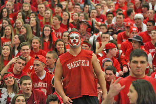 THE WMHS boys’ basketball team received tremendous fan support from the students at WMHS on Friday night in its Div. 2 North first round tournament game against Danvers. In the photo is a Warrior fan whose face is painted in the WMHS colors of red and white. (Donna Larsson Photo)