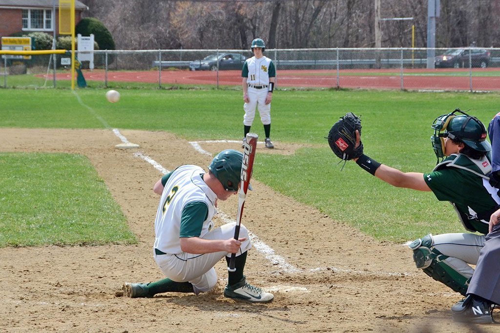 DUCK AND COVER. Tyler Stansbury (2) does well to get out of the way of this pitch in the Hornets vs. Hornets showdown game between North Reading and Manchester–Essex. (John Friberg Photo)