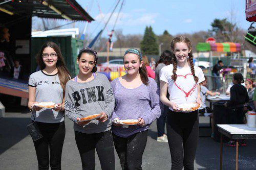 APRIL SCHOOL VACATION has traditionally meant a carnival at the Galvin Middle School and 2015 is no different. Basia Holowenczak, Natalia Frate, Sophia Rossicone and Katie Sweeney, all in the seventh grade at the middle school, enjoyed some fried dough yesterday. The carnival runs through Saturday night. (Donna Larsson Photo)