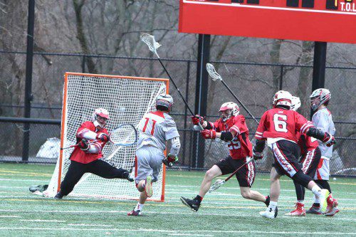 BRANDON GRINNELL (#11) tallied four goals for the Warrior boys’ lacrosse team on Friday afternoon at Landrigan Field. Despite a comeback effort in the fourth quarter, Wakefield was edged by Reading, 10-9, as it suffered its first loss of the season. (Donna Larsson Photo)