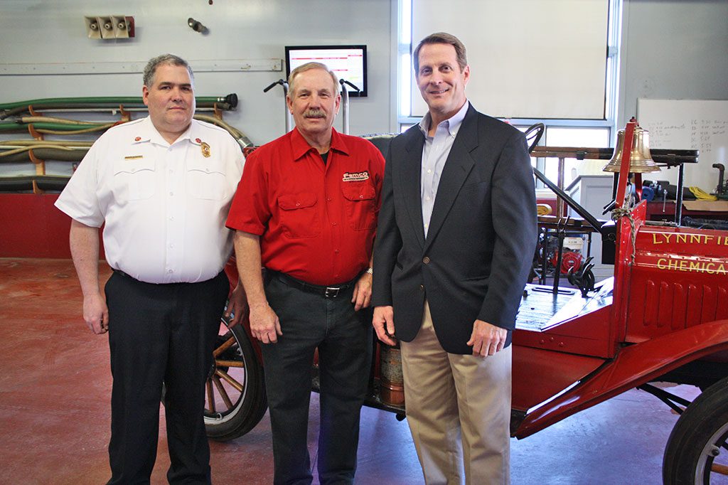 RETIRED FIREFIGHTER Al Burnham (center) donated $10,000 to preserve the fire department’s 1915 American LaFrance Ford Model T Chemical 2 fire truck on Wednesday, April 22. The generous donation, which was graciously accepted by Fire Chief Mark Tetreault (left) and Selectmen Chairman Phil Crawford (right), will be used to preserve the antique fire truck. (Dan Tomasello Photo)