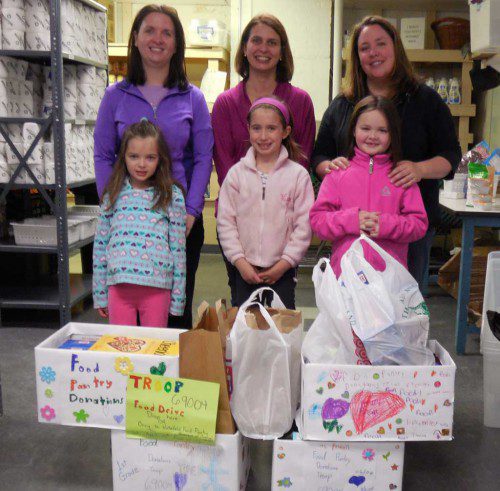 WAKEFIELD Girl Scouts Daisy Troop members are shown with food donations for the Wakefield Interfaith Food Pantry. From left: Hailey Napoleone with mom Heather Napoleone, Amelia Griffin with mom Robyn Griffin and Allison Pesa with mom Karen Pesa.  