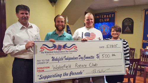 THE WAKEFIELD ROTARY CLUB joined the parade of local businesses supporting the town’s Independence Day Parade. Here, Rotary President Bob Mailhoit (left) and member Lisa Roderick present a check to Wakefield Independence Day Parade Committee Chairman Patrick Sullivan (second from left) and WIDPC Fundraising Chairman Paul Watts.