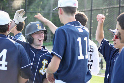 THE PLAYMAKER. Tom Anastasi is all smiles as he celebrates with his teammates after his game-winning RBI followed by scoring the fourth run in the 5-2 North sectional quarterfinal victory over Saugus Monday. (Maureen Doherty Photo)