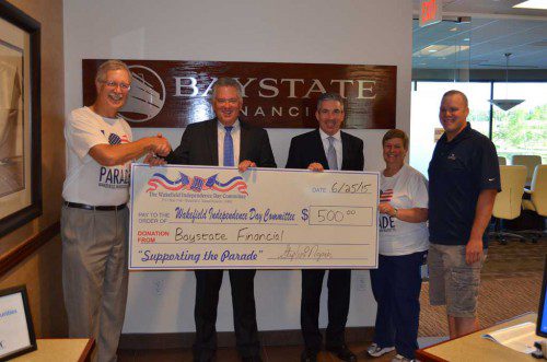 BAYSTATE FINANCIAL recently made a $500 donation to support the Wakefield Independence Day Parade, which will return after a two-year absence on Saturday, July 4. Pictured from the left are Dave Sidebottom, Michael Enright, Stephen Napier, Sandy Sullivan and Paul Watts.