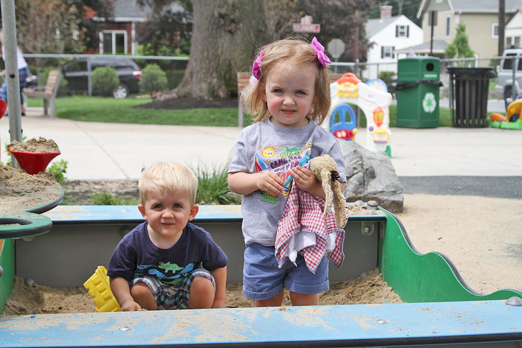 TWINS TIM AND VALERIE TURKOV, 2, hang out in the sand box at the Common. (Donna Larsson Photo)