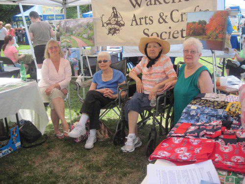 ALL things arts and crafts, too, were for sale at the Festival by the Lake last Saturday. Members of Wakefield Arts & Crafts Society shown are, from left: Ginny Cohen, Lois Tulikangas, Cindy Mallett and Nancy Kauffman. (Gail Lowe Photo)
