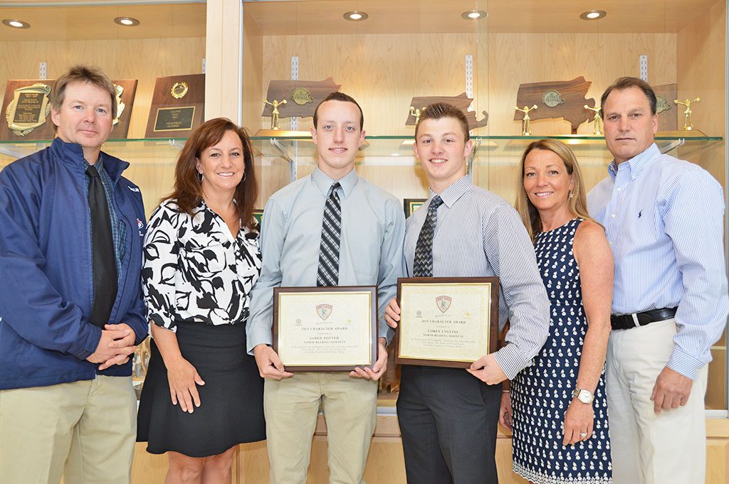 THE 2015 HOBEY BAKER AWARD for exemplary character and sportsmanship was awarded to two NRHS seniors, Jared Potter and Corey Collins, (center,) both captains of the NRHS 2015 varsity hockey team and also the boys lacrosse team. The award is given annually to athletes with outstanding work ethics and attitude. From left: varsity hockey coach John Giuliotti, who nominated the boys; Kathleen Potter and Jared; Corey, Katrina and Scott Collins. (Bob Turosz Photo)