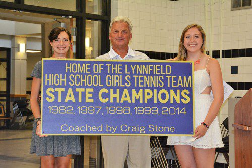 GIRLS’ TENNIS CAPTAINS Izzy Figucia (left) and Kelley Nevils proudly present a new sign to head coach Craig Stone at the Pioneers’ end of the season banquet last week. The sign, which honors the State Championships the Pioneers won under Stone in 1982, 1997, 1998, 1999 and 2014, will be hung at the Lynnfield High School tennis courts once the courts get redone. (Jane Skelley Photo)