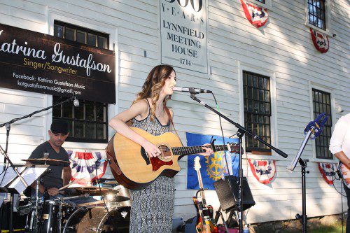 SINGER/SONGWRITER Katrina Gustafson gave a captivating performance at Rotary's weekly summer concert last Thursday. The LHS senior and her band performed a mix of her own compositions with country pop tunes for a large crowd on the common. (Maureen Doherty Photo)