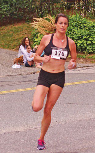 BRIGHTON resident Caroline King, 26, finished third in the 48th annual Lynnfield Athletic Association (LAA) Fourth of July Road Race in 17:18. King’s time was a women’s record in the road race. The previous record was 18:16, which was set by Maureen Forsyth in 2007. (Richie Blake Photo)