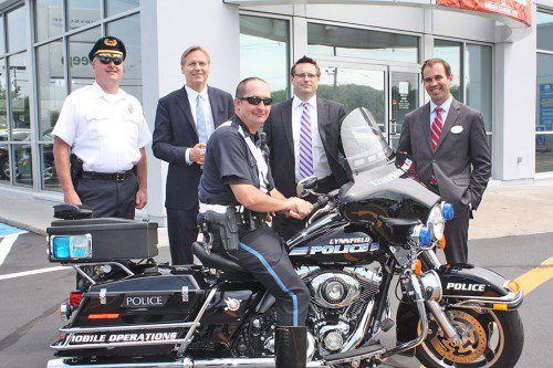 THE POLICE DEPARTMENT and Kelly Automotive Group renewed the lease for the police department’s Harley-Davidson Ultra Glide motorcycle for the fourth straight year on July 9. From left, Police Chief David Breen, Kelly Automotive President Brian Kelly, patrolman Patrick Curran, Kelly Jeep Chrysler Vice President Brian Kelly Jr. and Kelly Automotive Group Director of Operations Brian Heney. (Dan Tomasello Photo)