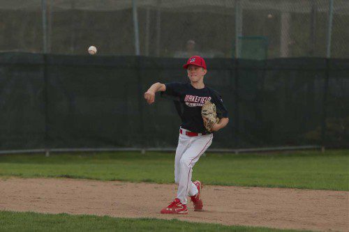 SHORTSTOP Jack Penney makes a throw to first base in a District 13 semifinal game on Tuesday night at Fernald Field. Despite a valiant effort, the Nationals dropped a 6-2 game against undefeated Reading. (Donna Larsson Photo)