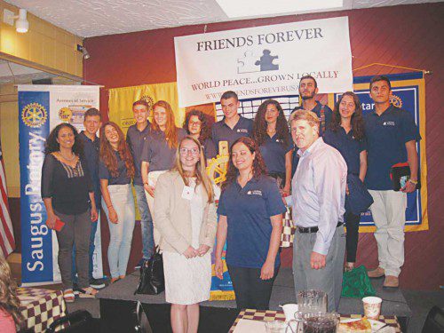 YOUTHS from Israel and Palestine were the guests of Wakefield's Rotary Club Monday night at a supper held at Prince Pizzeria on Rte. 1 in Saugus. The youths were chosen to visit the U.S. by Friends Forever, an organization that promotes world peace. Shown with the students are Casey Lyons, Saugus Rotary president and Robert Mailhoit, Wakefield Rotary president. (Gail Lowe Photo)
