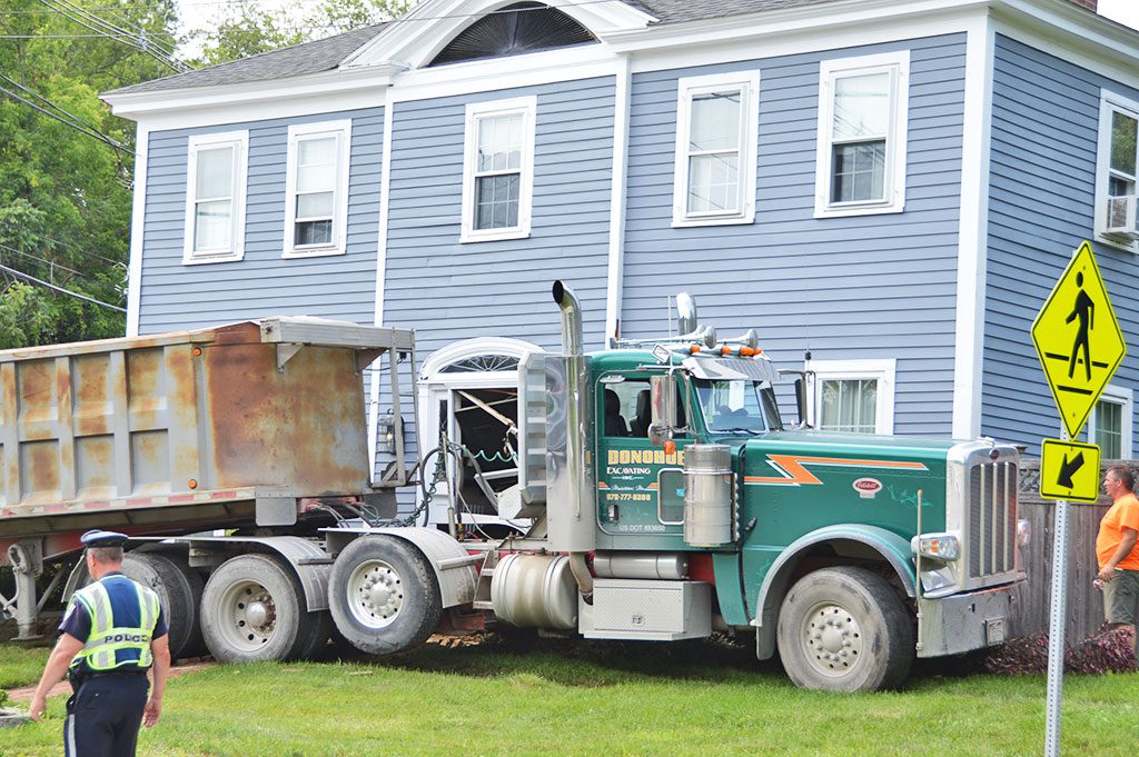 THE DRIVER OF THIS TRACTOR TRAILER lost control and hit the house at 219 Park St., the corner of Park and Central Sts. Tuesday afternoon, smashing into front entrance, causing extensive damage. No injuries were reported, either to the driver or the residents who were home at the time. The truck driver may have been cut off by another vehicle, causing him to lose control. The accident is under investigation by North Reading police. (Bob Turosz Photo)