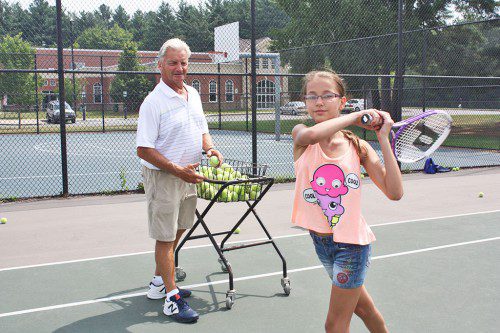 LYNNFIELD HIGH GIRLS’ TENNIS coach Craig Stone teaches 12-year-old seventh grader Alyssa Styller return techniques during a Lynnfield Community Schools (LCS) Tennis Camp on July 30. Stone has been running the LCS tennis camp for the past 30 years. (Dan Tomasello Photo)