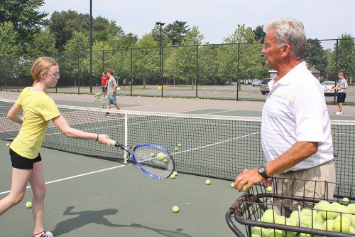 CRAIG STONE watches 12-year-old seventh grader Grace Mealey complete a return during a Lynnfield Community Schools Tennis Camp on July 30. The Lynnfield High School girls’ tennis coach has been running tennis camps for Community Schools for the past 30 years. (Dan Tomasello Photo)