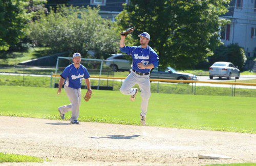 JOE BREEN (right) leaps up to make a catch at first base as John Davison (left) looks on during Sunday's game at Walsh Field. Breen doubled and had an RBI while Davison had a hit in Wakefield's 4-2 setback against the Andre Chiefs last night at Maplewood Field. (Donna Larsson File Photo)