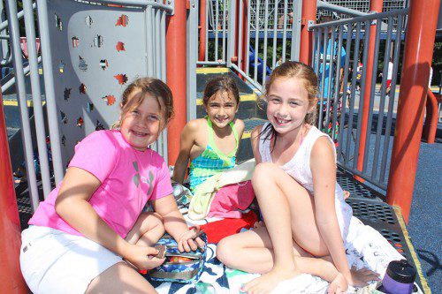 CAN WE TALK? Enjoying snack time while lounging on the play structure at Summer Street School are Recreation Station campers, from left, Lucia Dias, 8 1/2, Gianna Micieli, 7 1/2, and Maddie McCarthy, 8. (Maureen Doherty Photo)