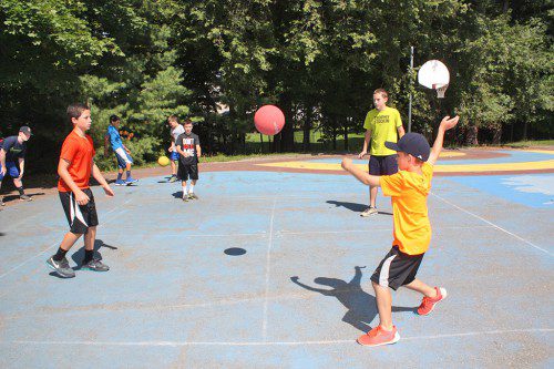 FOUR SQUARE remains one of the most popular of the classic playground games at Recreation Station where the grids are always full. Engaged in a game are (clockwise from lower right): Sean Drzewiczewski, Ronald Fuccillo, Nick Marino and Matt Stephens. (Maureen Doherty Photo)