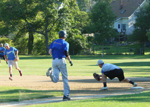 STEVE BOGHOS (left) makes the throw to Dave McDonald (right) at first base to get runner Matt Byrne out. Boghos and McDonald both had hits and McDonald scored one of the four Expos runs in their 4-1 triumph over the Brewers last night at Moulton Field. (Donna Larsson File Photo)