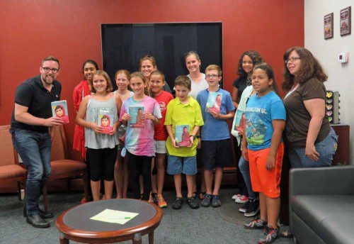 WAKEFIELD students and parents gathered at Wakefield Co-operative Bank’s main office at 342 Main St. Wednesday, August 5 for a Wakefield Reads “Book Buzz.” Wakefield Reads is a public schools initiative aimed to promote reading among students and parents during summer months. The program is also supported by the Wakefield Lynnfield Chamber of Commerce and Beebe Library. The 2015 summer book selection was “I Am Malala” by Malala Yousafzai and all ages were invited to partake in the program by reading an age- appropriate edition of the book. Teacher Allen Drinkwater is shown with students and parents. (Courtesy Photo)