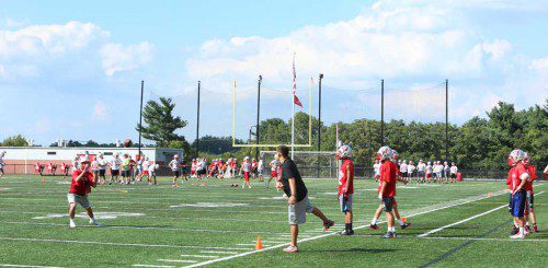 THE WMHS football team has begun practicing for the upcoming season. Several players are taking part in receiving drills yesterday at Landrigan Field. (Donna Larsson Photo)