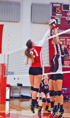 A BLOCK KILL for Melrose junior Cat Torpey, who has been a menace in the front row for the Lady Raider volleyball team, now 2-0 in the season. (Steve Karampalas photo)
