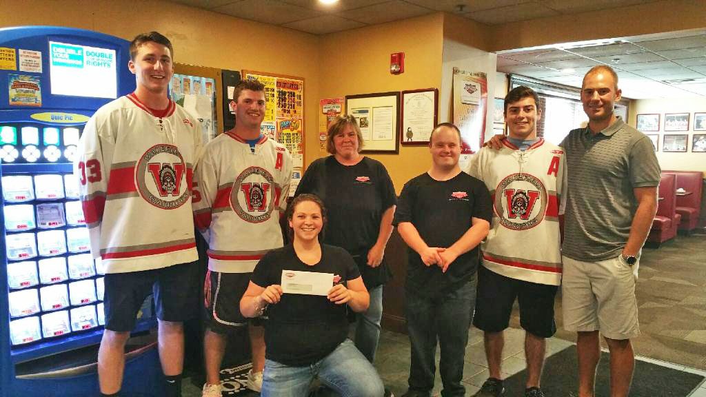 THE DOCKSIDE RESTAURANT has always been a supporter of Wakefield athletics, with the latest example being a Wakefield Memorial High School clinic the Dockside sponsored. Members of the varsity hockey team in this photo are, from the left, Ben Yandell, Dylan Melanson, Anthony Funicella and head coach Chris Gianatassio on far right. Members of Dockside staff giving the team members are check are, from the left, Samantha Fuschetti, Shannon Thompson and Dan Gill.