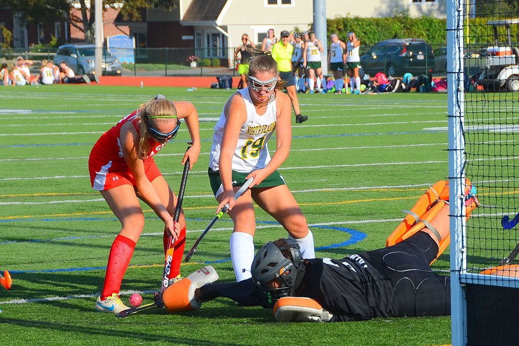 STOUT DEFENSE. Junior Julia Perrone (on the ground) makes a great stop against her Masco opponent while Gabby Lanzaro (19) helps out. (John Friberg Photo)