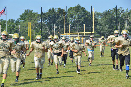 PRACTICE SESSIONS continued for the football team this week with sprints up and down the field in the blazing sun. The team opens the season Friday against Ipswich. (Bob Turosz Photo)
