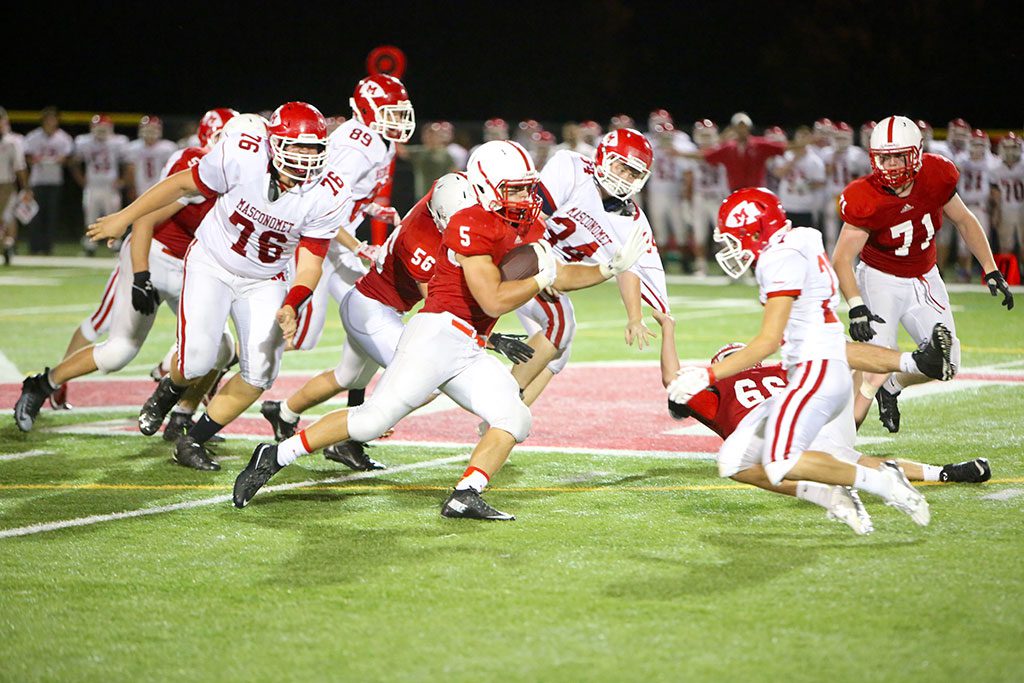 MIKE PEDRINI was unstoppable last Friday night for the Melrose Red Raider football team, who won their season opener against Masconomet 41-14 at home. The junior running back scored 3 TDs and ran for over 100 yards to help Melrose start their season 1-0. (Donna Larsson photo) 