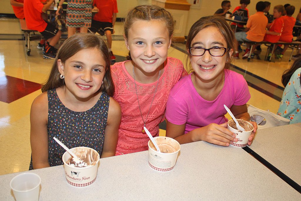 CLOSE FRIENDS, from left, Ella Pescione, Trinity Gesamondo and Evyenia Georges were thrilled to be spending part of their first day of school enjoying ice cream during the middle school’s annual fifth grade ice cream social on Sept. 1. The Middle School PTO sponsored the event.  (Dan Tomasello Photo)