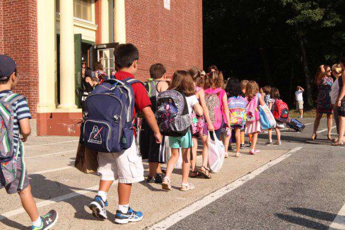 MOST OF THE TOWN’S public school students began the 2015-16 academic year this morning. Here, Greenwood first graders march into the 119-year-old building on Main Street. Pre-schoolers and kindergartners start tomorrow.  (Donna Larsson Photo)
