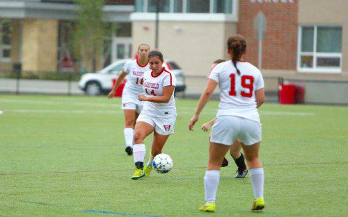ISA CUSACK (#14) chases down the ball as teammates Jillian Fiore (#16) and Mia Joyce (#19) look on. The Warriors edged Melrose for a 2-1 score for their first win of the year. (Donna Larsson File Photo)