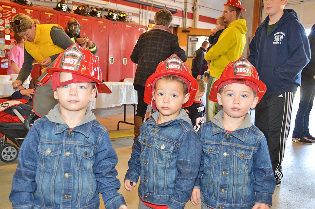THE TAYLOR BROTHERS – Adam, Andrew and Aaron – are ready for anything at the Fire Department’s Open House held Sunday. (Bob Turosz Photo)