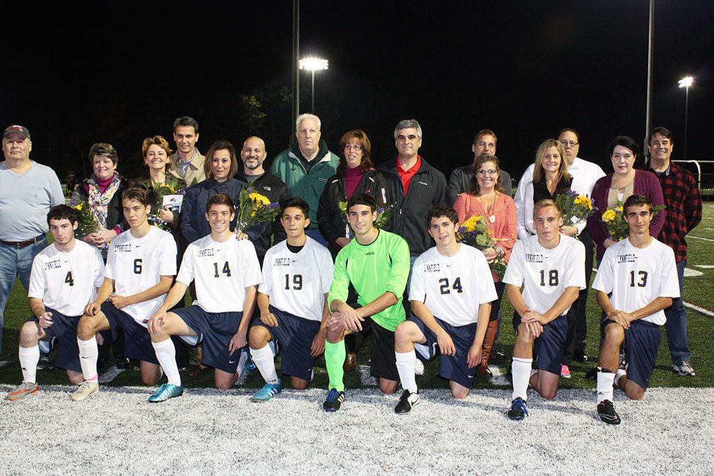 THE PIONEERS honored their seniors during senior night on Oct. 22, when the Pioneers tied Newburyport 1-1. Front row, from left, Thomas Anastasi, Jakub Jablonka, Zach Bisconti, Filippo Garini, Nick Colucci, Matt Weiss, Matt Lannon and Ian Wallace. Back row, from left, Peter and Karen Anastasi, Anna and Rafal Jablonka, Julie and Nick Bisconti, Bruce Weaver, Lisa and David Colucci, Nancy and Jay Weiss, Ted and Patti Lannon, Margaret Gilligan and Andrew Wallace. (Dan Tomasello Photo)