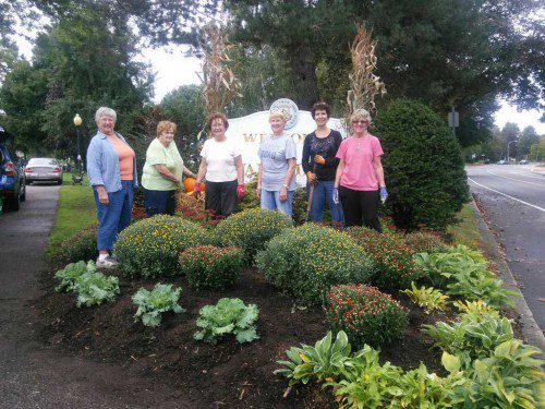 AN ON-GOING objective of the Wakefield Garden Club (WGC), members removed spent summer blooms for an autumn theme at the Welcome to Wakefield sign at the corner of Church and Main streets. They used chrysanthemums, cabbage and pumpkins and corn husks alongside Autumn Joy sedum and hosta.  Pictured here from the left are Janet Bringola, Barbara Carino, Joan Chetwynd, Maureen Coughlin, Diane Kelley and Kathy Powell.