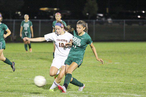 TOE TO TOE. Junior Midfielder (number 11), Haley Nathan pushes the ball upfield against her Ipswich opponent. (Courtesy Photo)