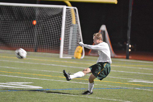 SENIOR MIKE DRISCOLL makes sure the ball doesn't get anywhere near the net in this recent game at the Kenney Turf Field. (Bob Turosz Photo)