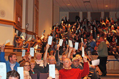 A HAND COUNT was taken at Town Meeting Monday to determine the exact outcome of votes for and against Article 4. The citizens' petition seeking to expand the number of selectmen from three to five failed by a 3 to 1 margin, 318-109. (Maureen Doherty Photo)