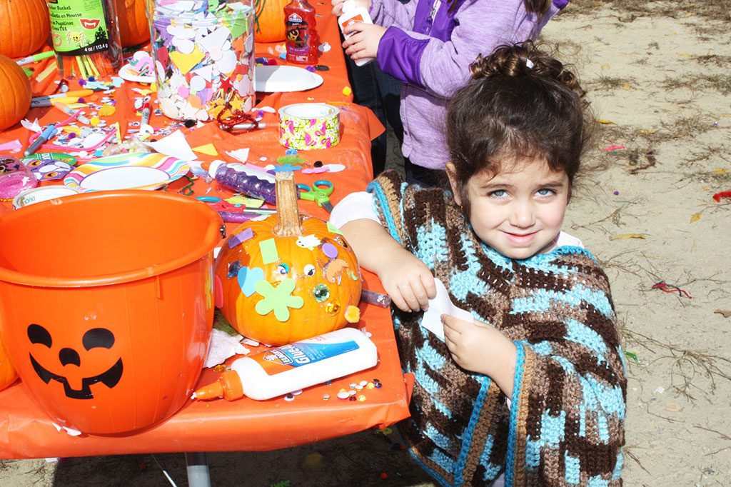YOUNGSTER Gianna Kouyoumdjian shows off a pumpkin she decorated at the annual Pumpkin Fair on Oct. 17. The Pumpkin Fair was sponsored by the Summer Street School PTO.  (Dan Tomasello Photo)