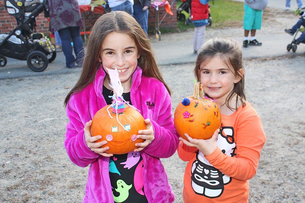 SISTERS Ella (left) and Sabrina Hayman show off pumpkins they decorated at the annual Pumpkin Fair at Summer Street School Oct. 17. (Dan Tomasello Photo)