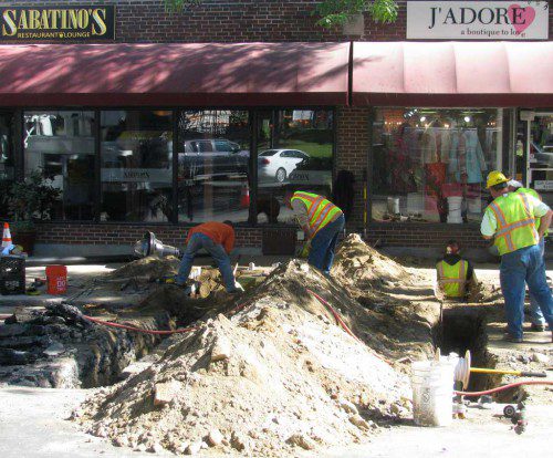 MUNICIPAL GAS and Light Department crews have been working this week to tie downtown businesses on the east side of the north end of the downtown area into the new gas main that was installed in the square this past summer. (Mark Sardella Photo)