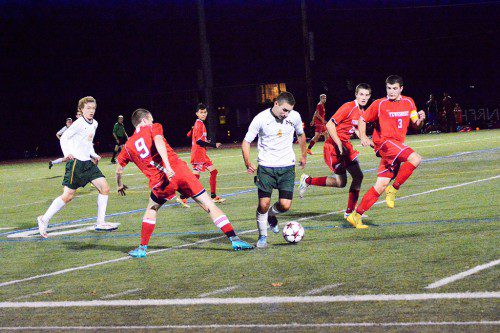 HORNET JUNIOR Anthony Tramontozzi pushes through several Redmen opponents in MIAA tournament play against Tewksbury. (Deanna Castro Photo)