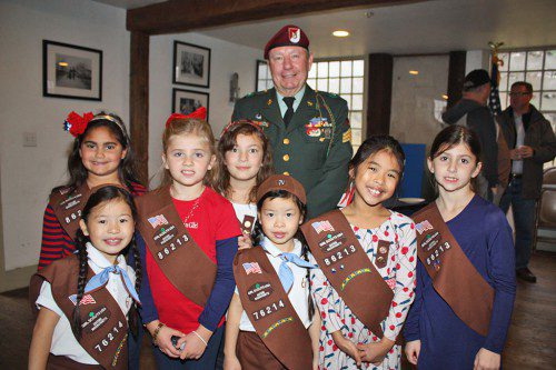 BROWNIES from Lynnfield troop 86213 at OLA School and 76214 from the Summer Street School enjoyed talking with Vietnam veteran John Lukas and learning about the various service medals he earned as a member of the 82nd Airborne Division of the U.S. Army on Veterans' Day. Front row from left: Lorelei Eckhardt, Grace Ditchfield, Annabelle Eckhardt, Alana Doroquez and Shea Mason; back row, from left: Angelica Zizza, Genevieve Doucette and John Lukas. (Maureen Doherty Photo)