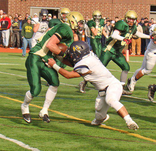 BIG PLAY. Senior Alex Soden (5) hauls down Hornet running back Matt McCarthy (25) for a 6-yard loss from the Pioneer 8-yard line on a critical third down play. The play forced the Hornets to settle for a first quarter field goal. (Tom Condardo Photo)