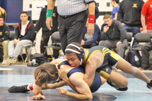 SENIOR Kai Jean-Simon (on top) defeated his Essex Tech opponent by fall in 1:05 in the 126 lb. weight class Dec. 23. The Black and Gold defeated Essex Tech 58-22. (Courtesy Photo) 