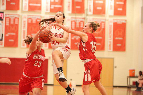 ALI BORNSTEIN goes for a basket during the Melrose Lady Raider hoop team's league win over Wakefield. (Donna Larsson photo) 