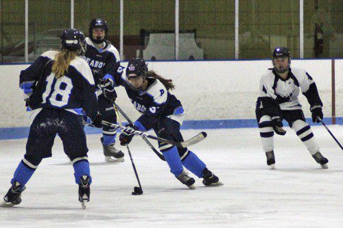 ASHLEY BARRETT (with puck) skates with finesse in the team's 5-0 shutout over Shawsheen. Teammate Mae Norton (18) is ready to assist. (Mark Grant Photo)